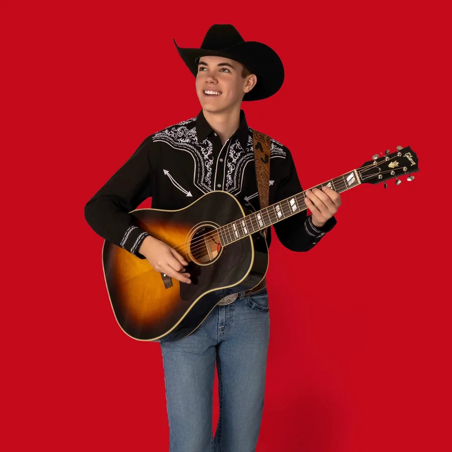 AJ Robinson studio portrait on a red backdrop, available autographed
